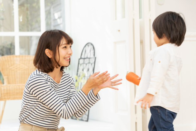 ママにニンジンを渡す子供